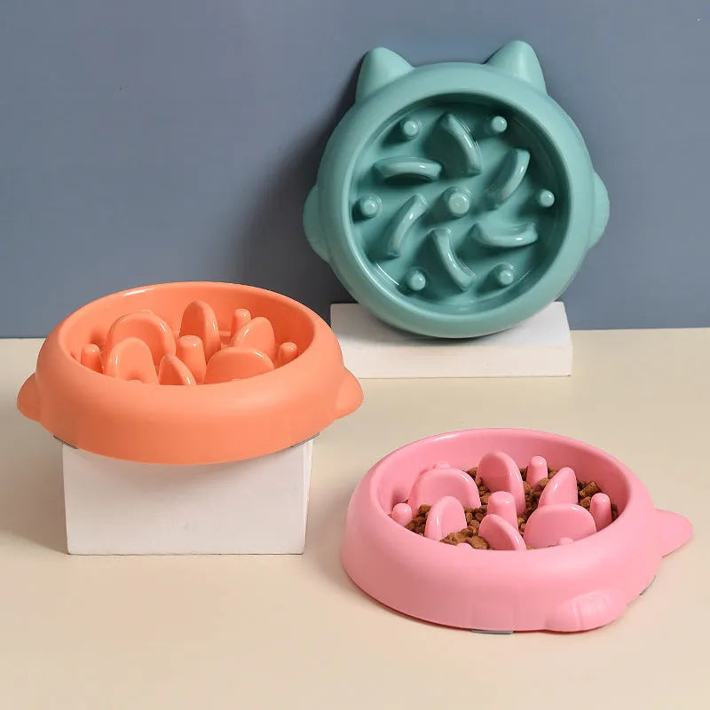 Green pet slow feeder bowl with raised internal maze design for dogs and cats