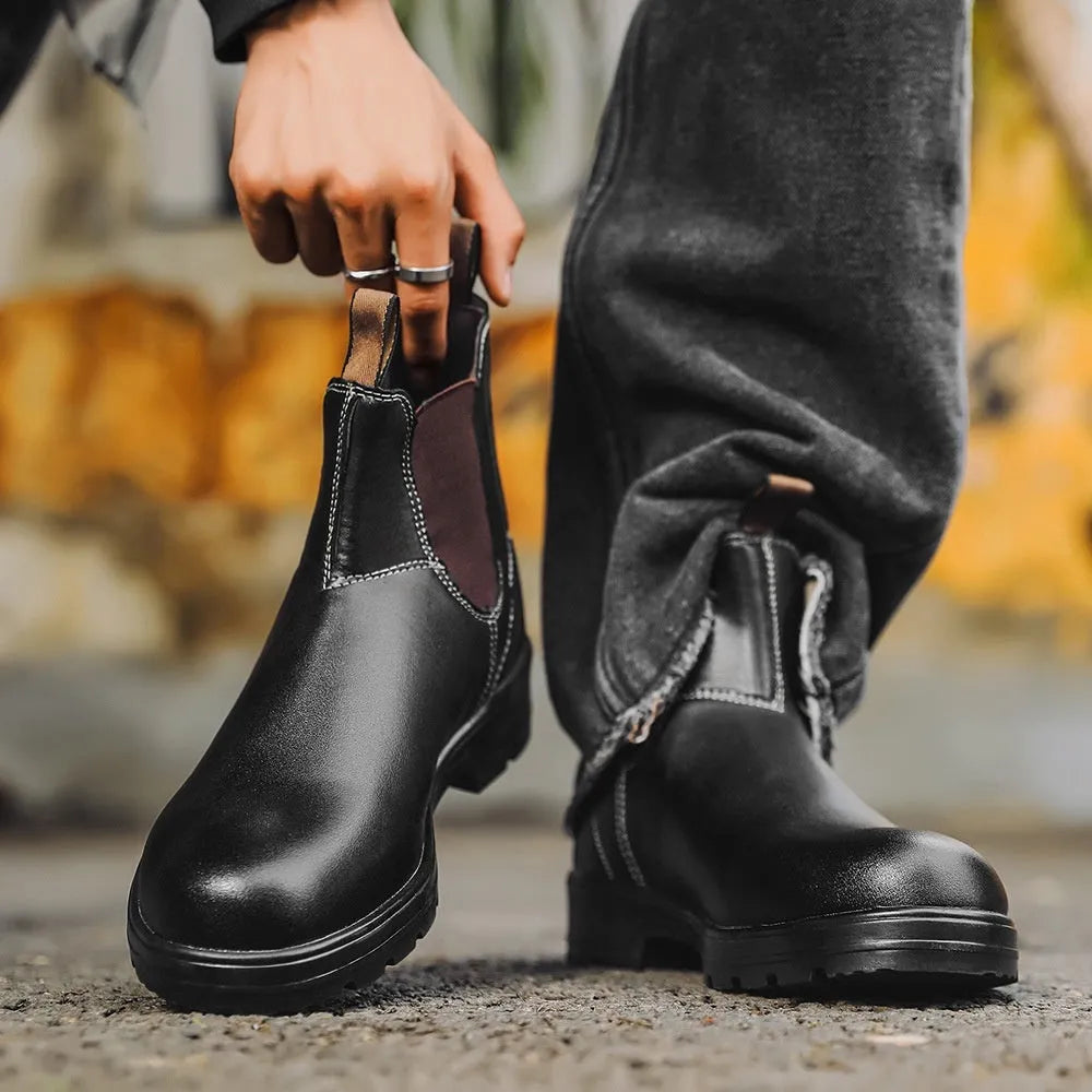 Vintage brown unisex Chelsea boot with frosted PU upper and round toe on a wooden surface.