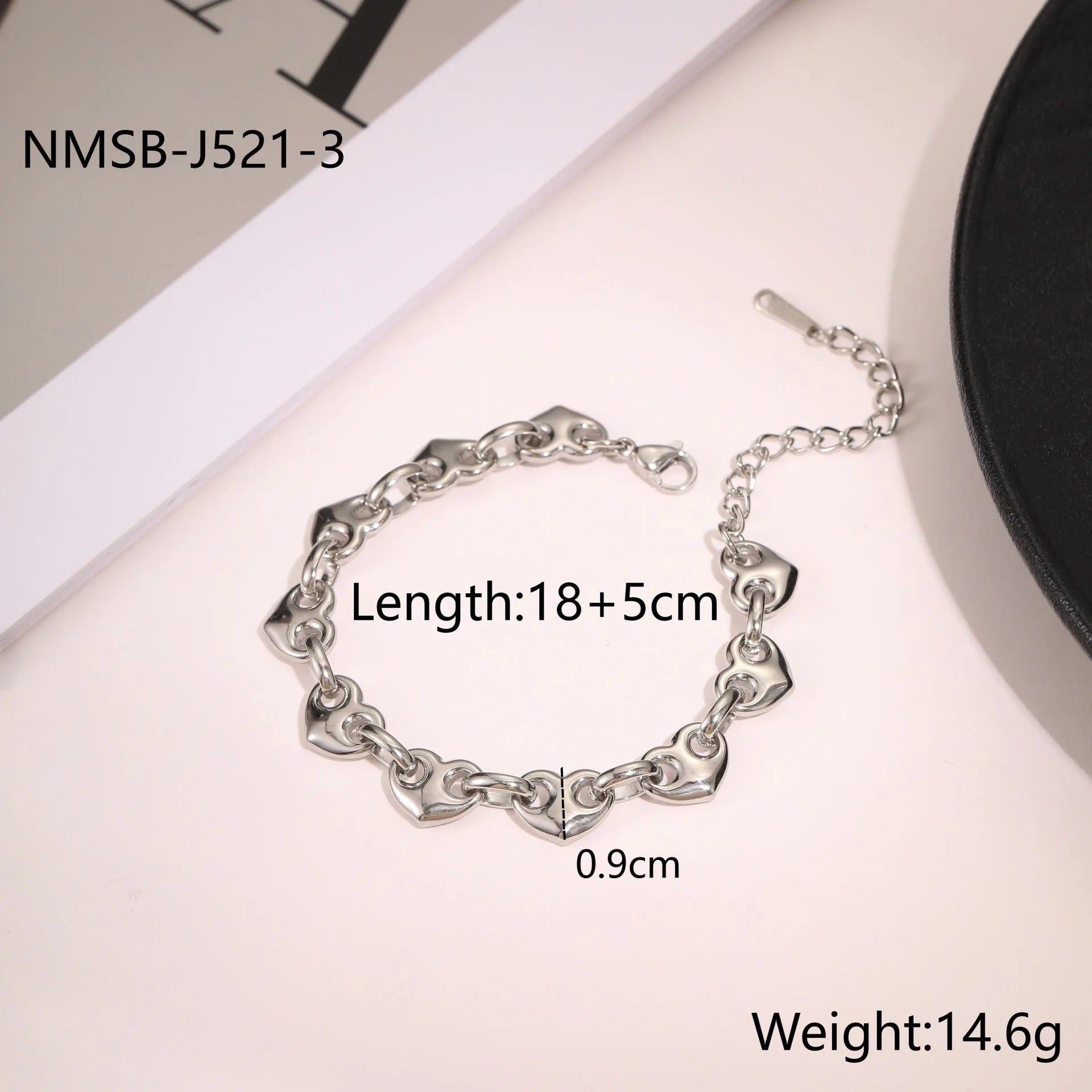 Stainless steel bracelet with a hollowed-out heart charm in a gold electroplated finish.