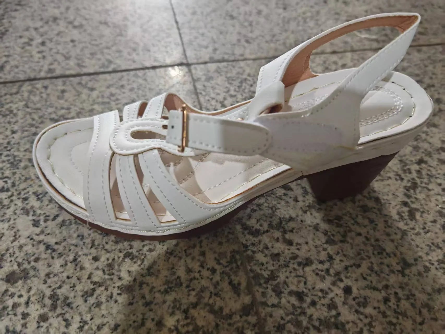 Women's black peep toe wedge sandals with a buckle fastening and platform sole.
