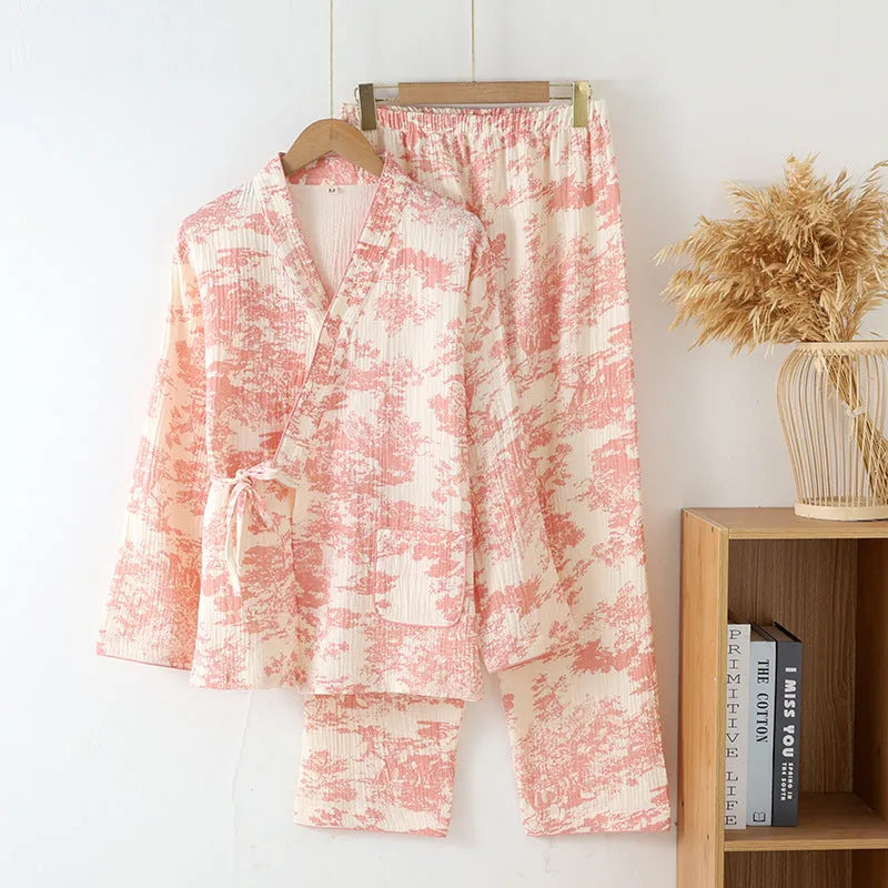 Women's pink cotton gauze long sleeve top and trousers matching loungewear set laid flat.
