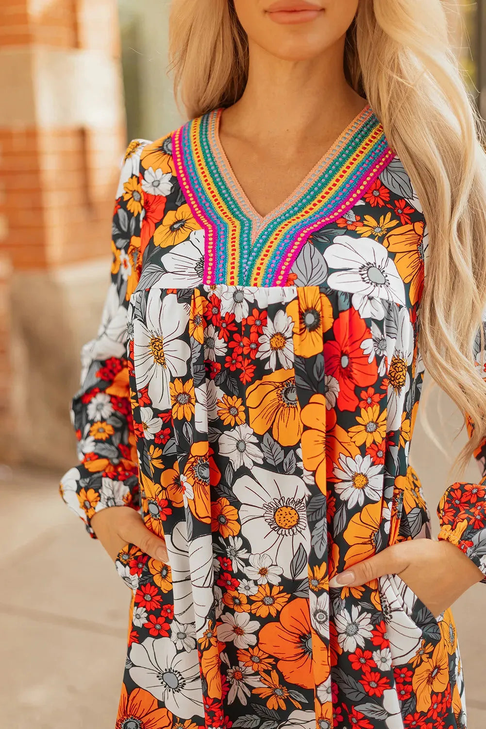 Orange floral print women's mini dress with lace-trimmed V-neck and long sleeves.