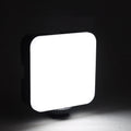 Compact square on-camera top flash unit with hot shoe mount and rotatable head.