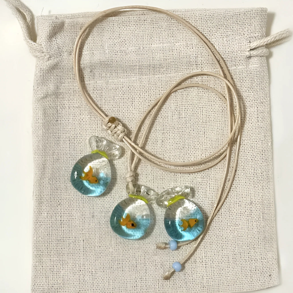 Women's necklace with coloured glaze joker charm on cotton linen chain in small fish lucky bag colour