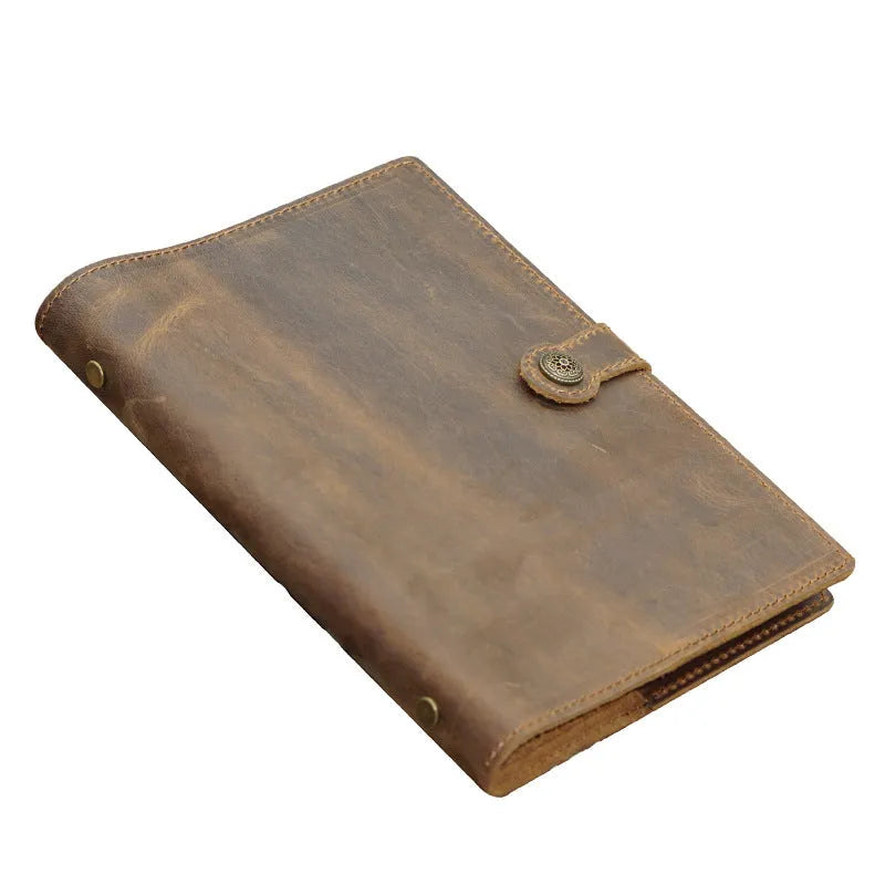 A5 handmade cowhide notebook with genuine leather cover in Crazy Horse Brown, opened on a table