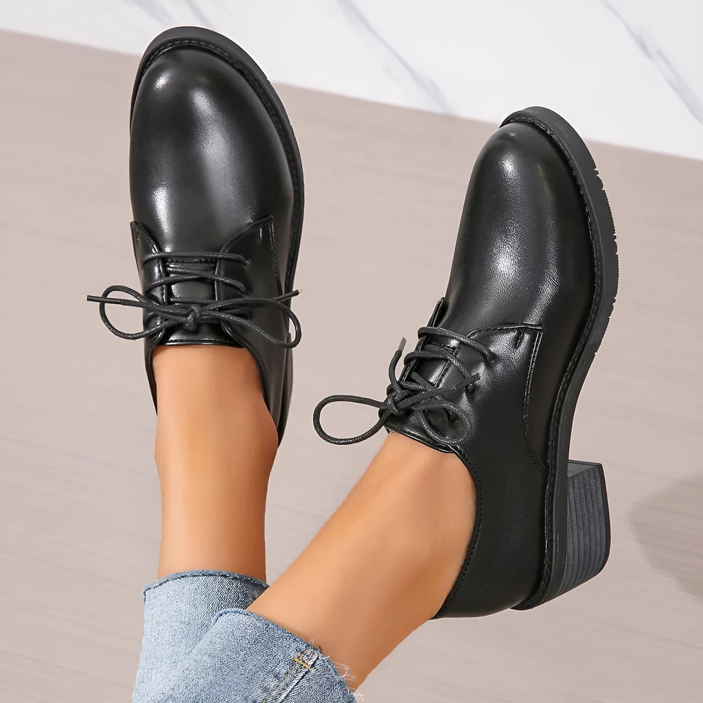 Black women's low-top shoes with a chunky thick heel and rubber sole.