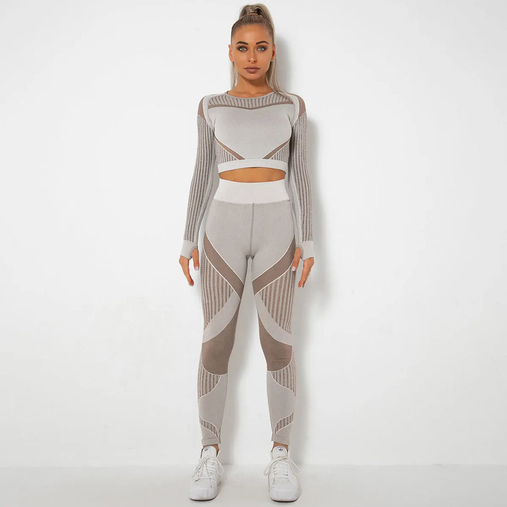 Women's black seamless knitted long-sleeved yoga wearsuit with stripe pattern, shown in a yoga pose.