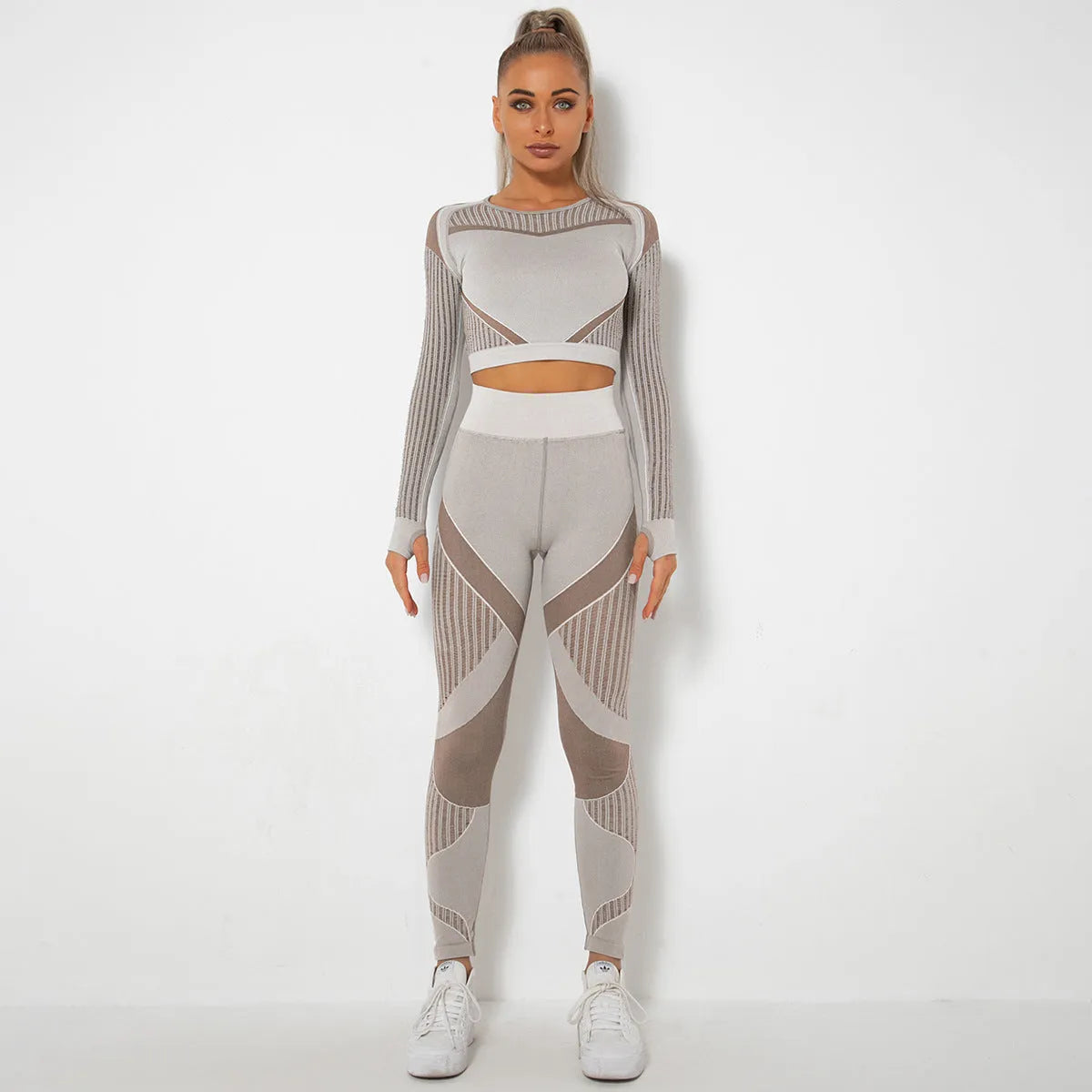 Women's black seamless knitted long-sleeved yoga wearsuit with stripe pattern, shown in a yoga pose.