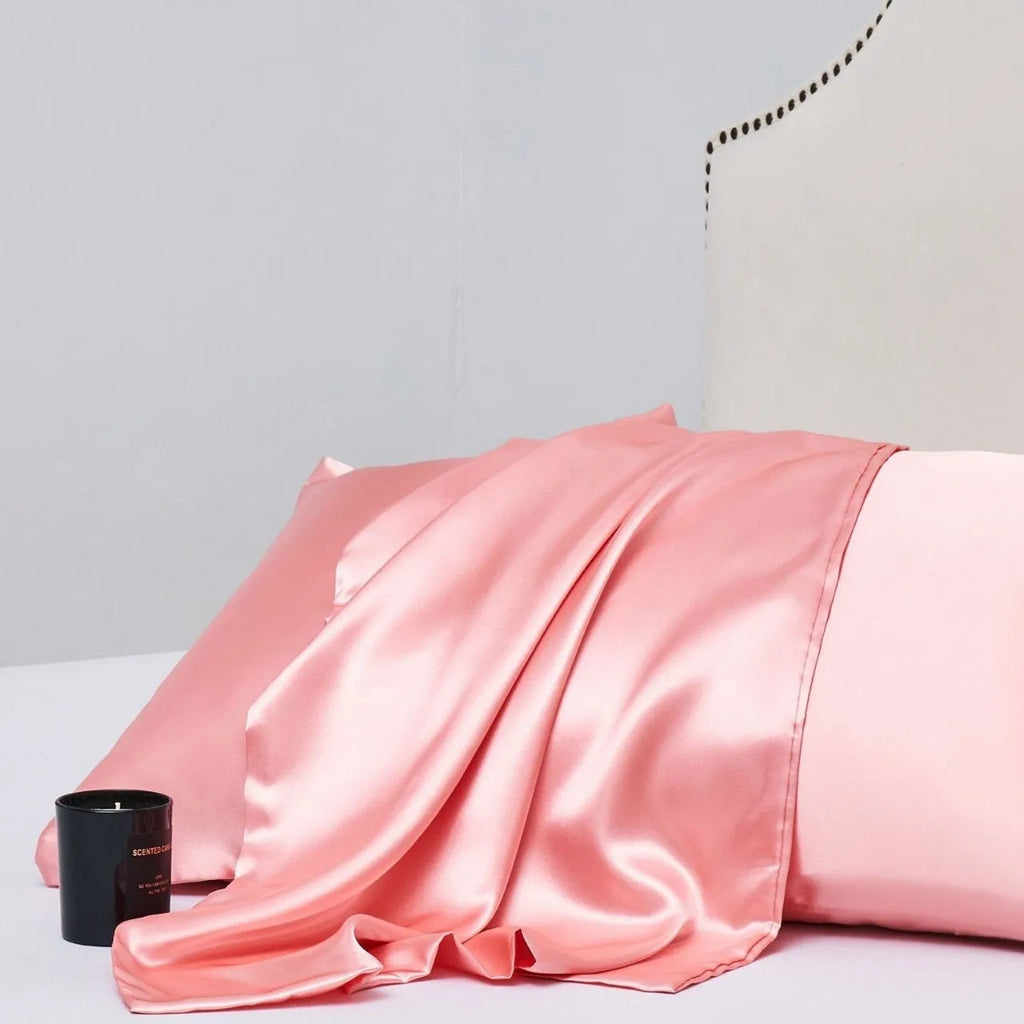 A pair of solid colour satin pillowcases in a chosen shade, showing the smooth plain weave fabric texture.