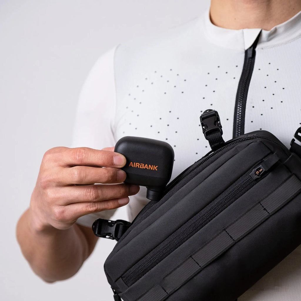 Black AS100 mini electric bike pump with USB charging cable and waterproof storage bag