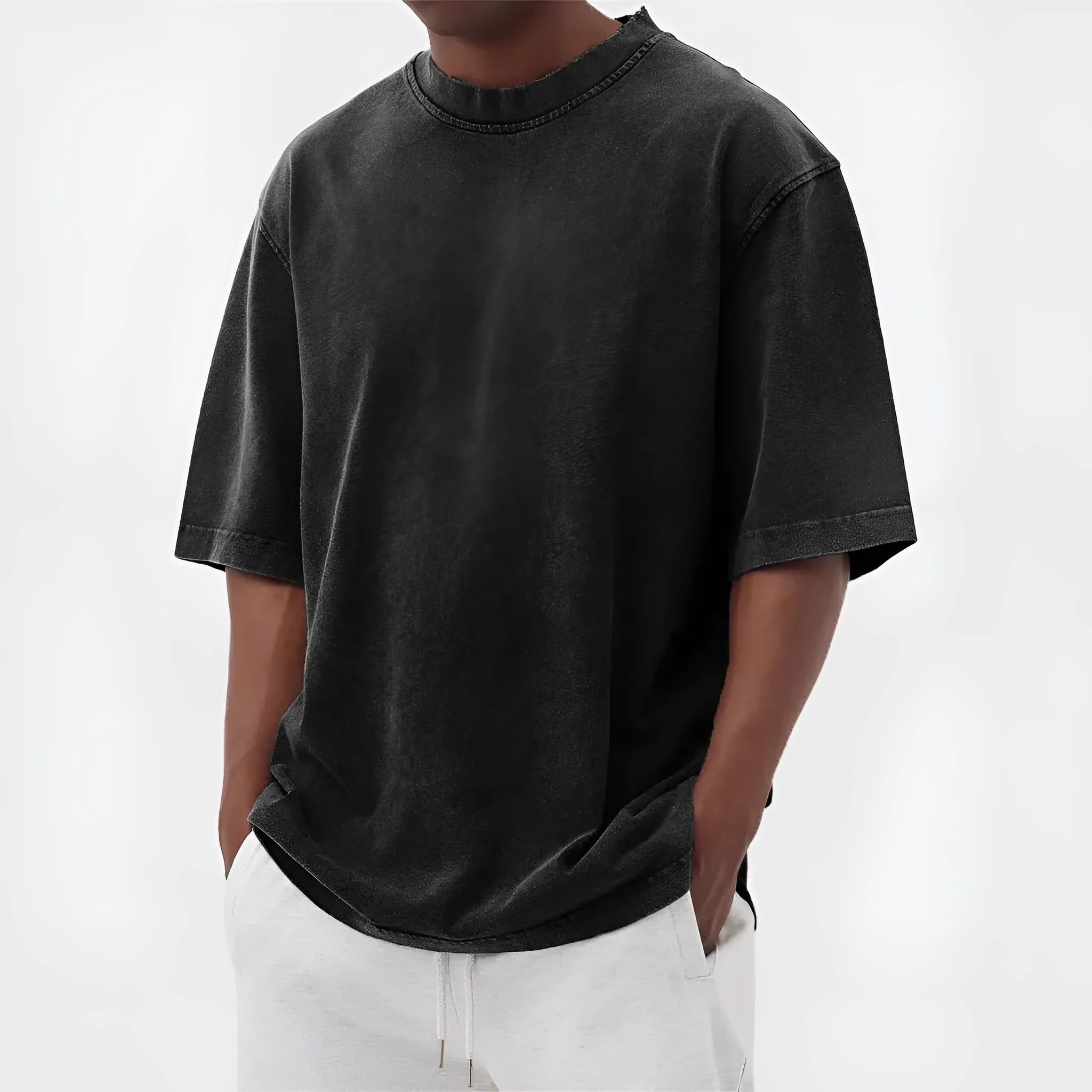 Man wearing a loose-fit, stone-washed distressed pullover T-shirt in a solid colour.
