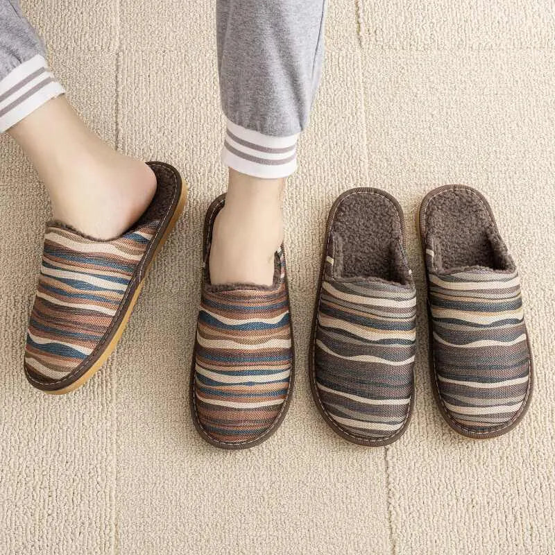 A pair of linen surface cotton lined slippers with a PVC sole, shown in a floral print colour option.