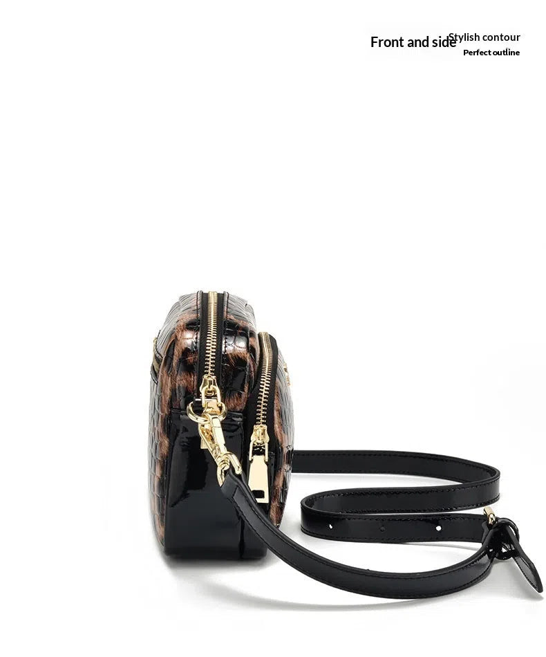 Leopard print crossbody phone bag with PU finish, zip pocket, and 120 cm shoulder strap on neutral background
