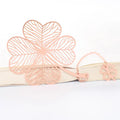 Brass metal bookmark with hollow leaf pattern design and rose gold tassel