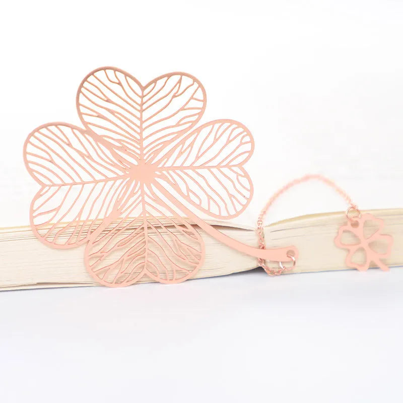 Brass metal bookmark with hollow leaf pattern design and rose gold tassel