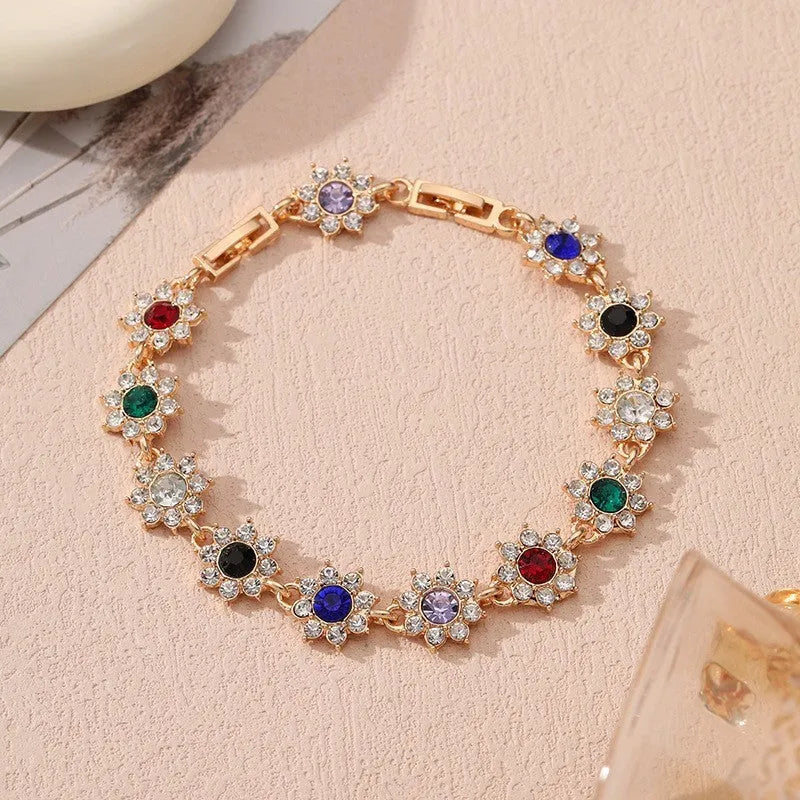 Zinc alloy flower bracelet with electroplated colour finish and colourful crystal decorations in gold and silver variations