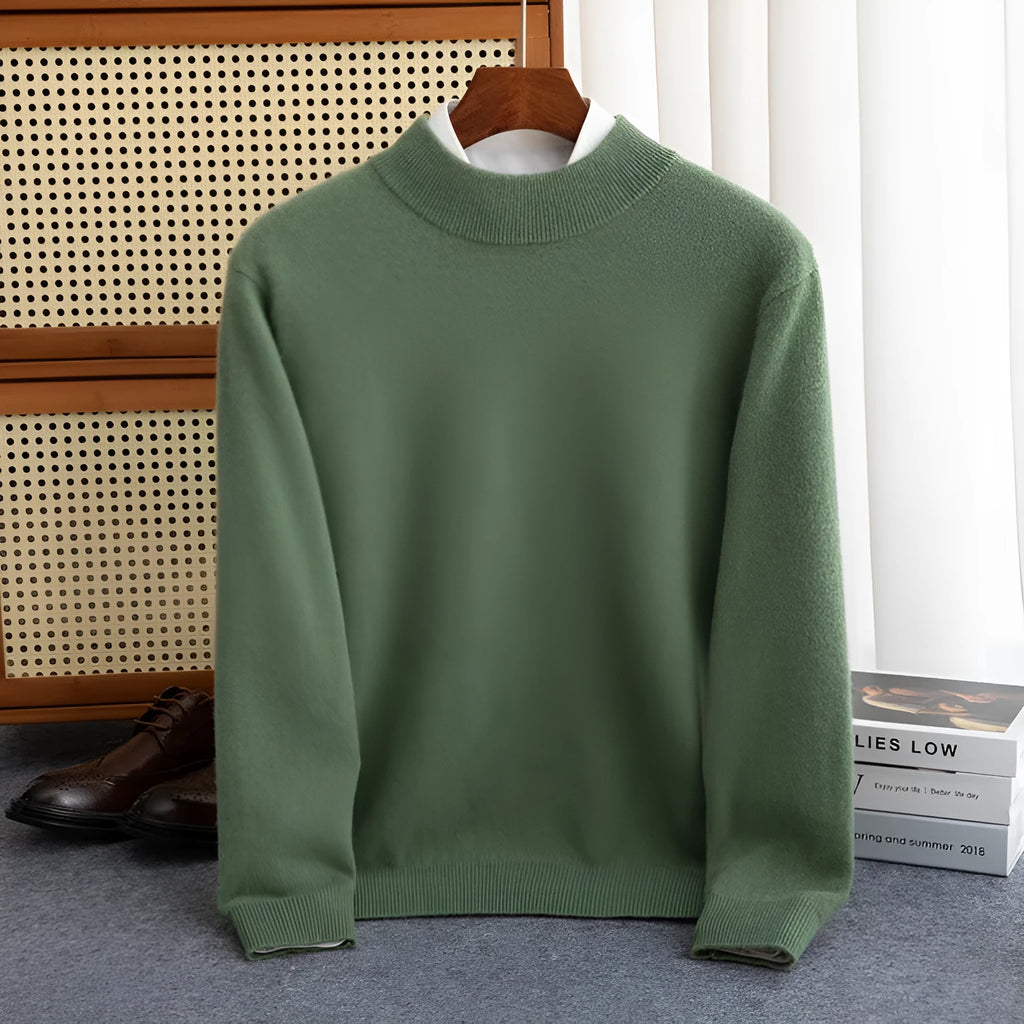 Man wearing a loose-fit, chunky knit wool sweater with a half-turtleneck collar in a neutral colour.