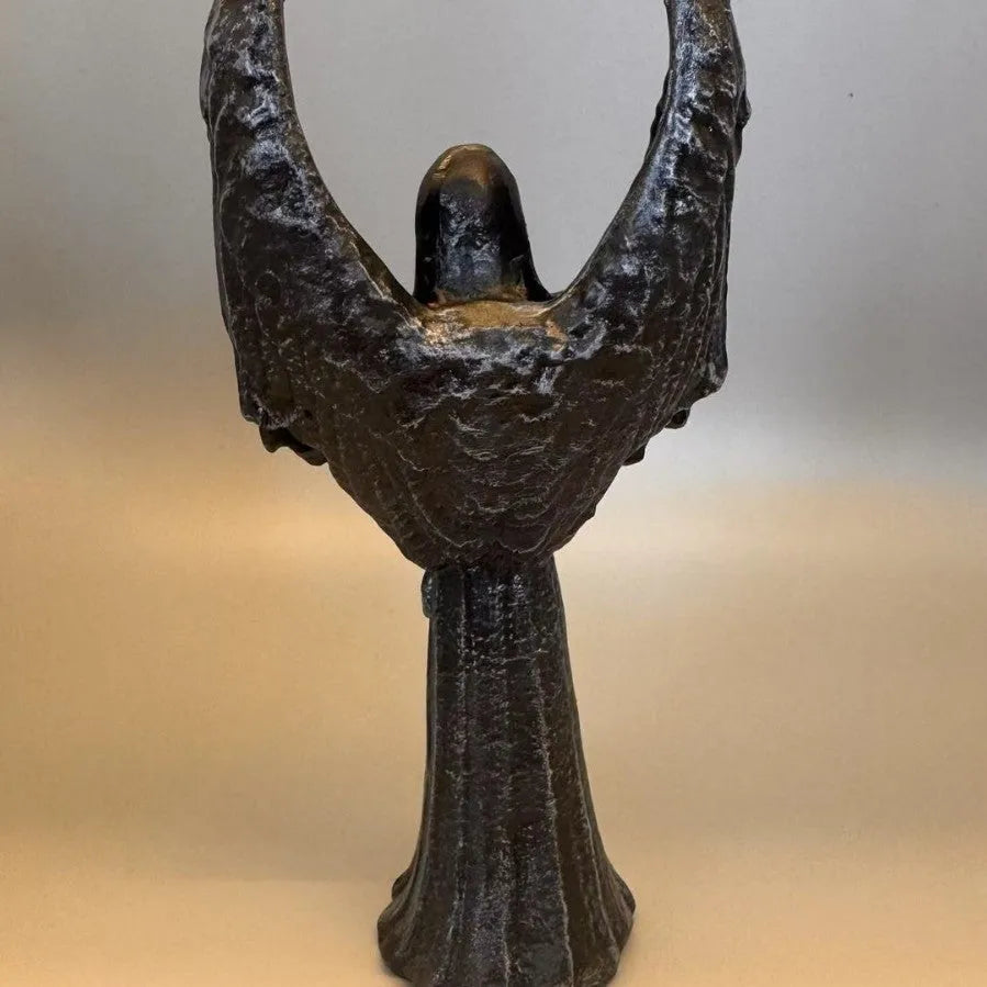 Dark angel resin statue ornament on a shelf, showing detailed sculptural form and dark colour finish.