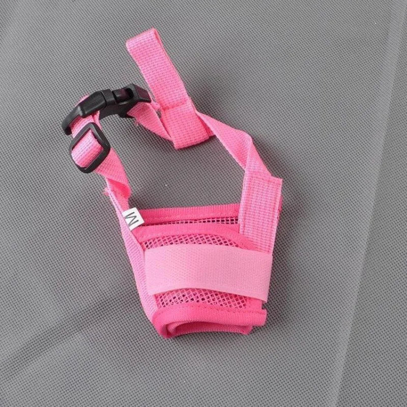 Adjustable plastic basket-style dog muzzle in red, shown on a dog's snout with quick-release buckle.