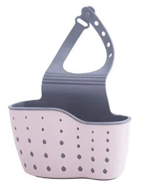 Set of three plastic kitchen sink storage racks in light blue, light pink, and beige on a countertop