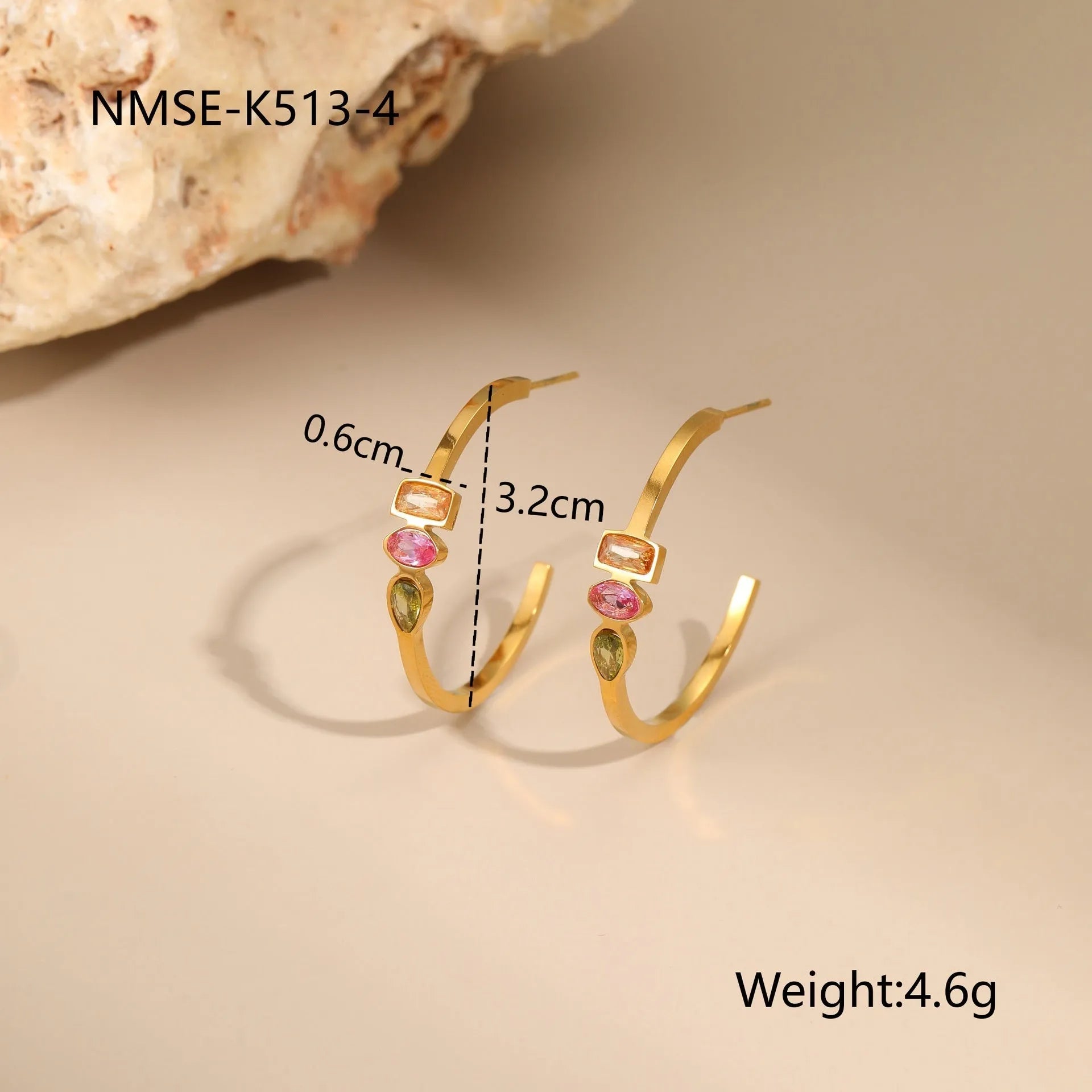 Geometric colour zircon gold plated jewellery set showing necklace, earrings and ring on black background