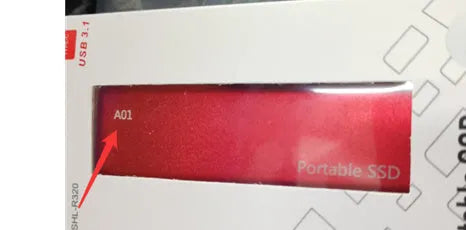 Red ultra-thin metal external SSD hard drive with high storage capacity on a desk.