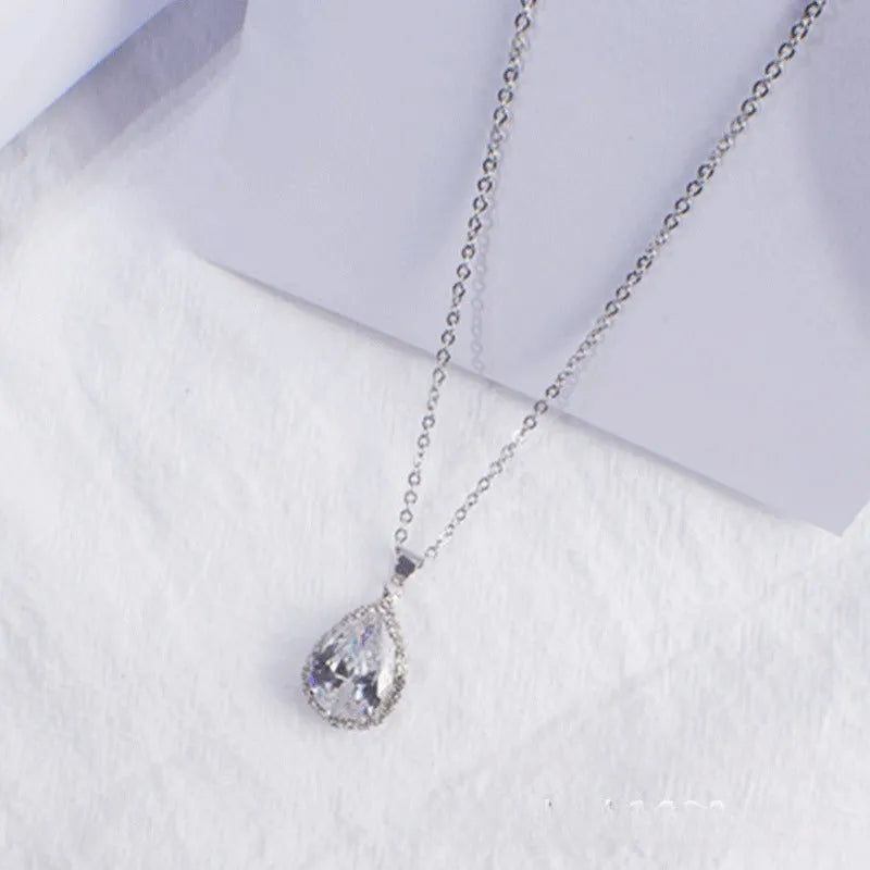 Rose gold water drop shape necklace with rhinestone geometric detailing in pink colour