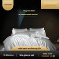 Silk four-piece quilt cover set in solid colour showing champagne gold bedding on bed