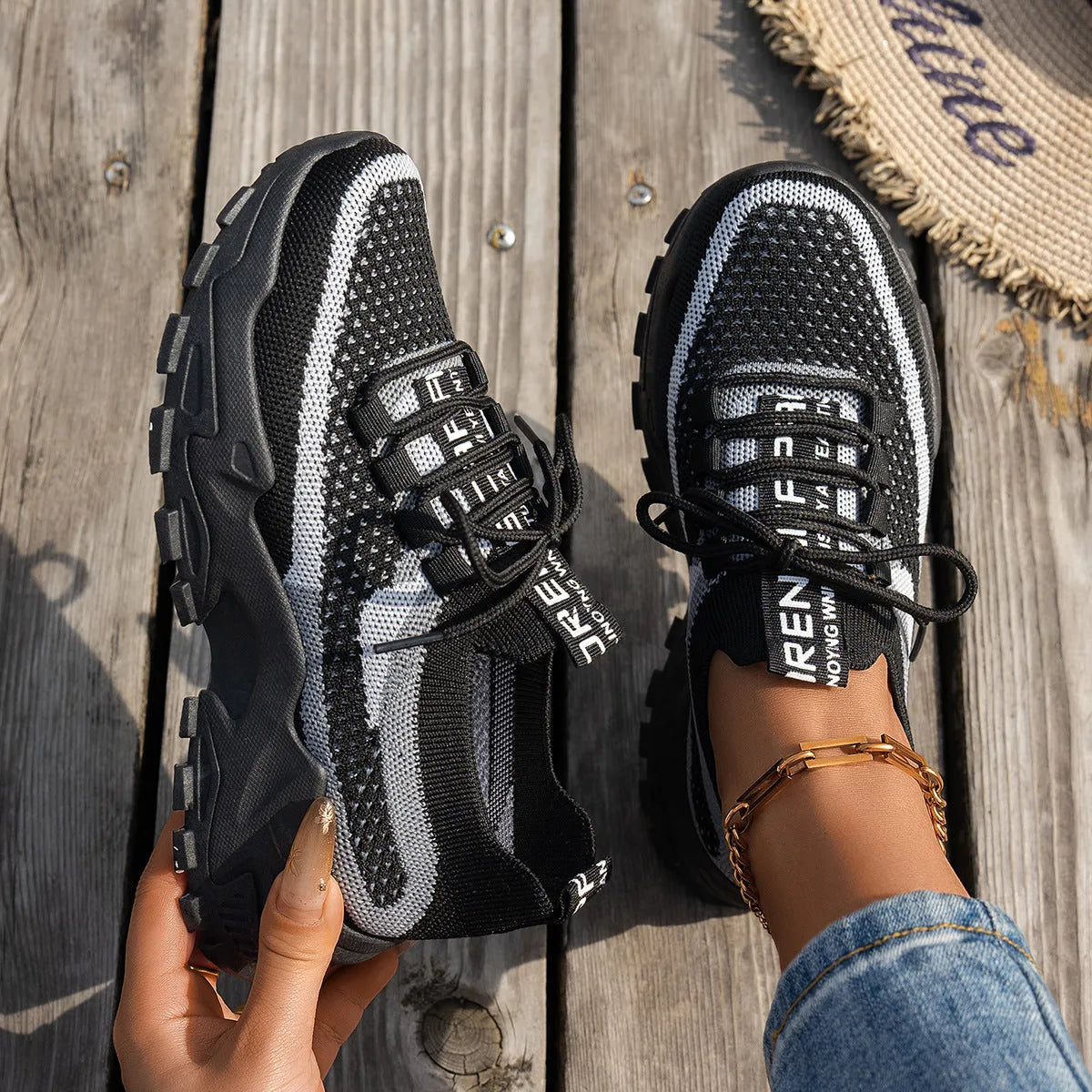 Women's Flyknit mesh lace-up sneaker in a grey colourway, showing the breathable upper and rubber sole.