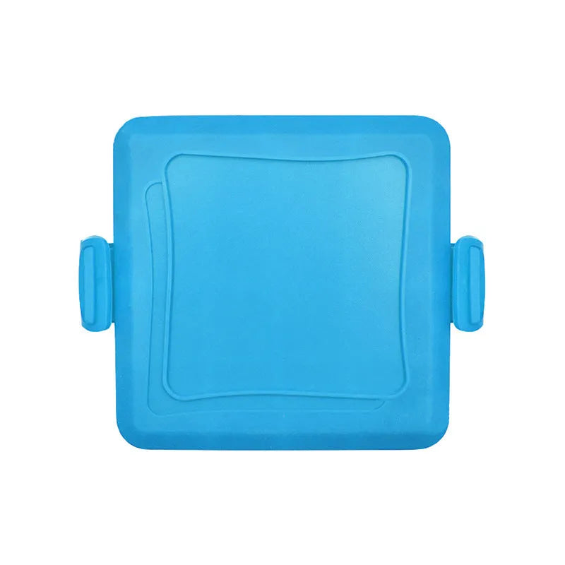 Red silicone baking tray with integrated handle and a pair of matching silicone oven gloves on a kitchen counter.
