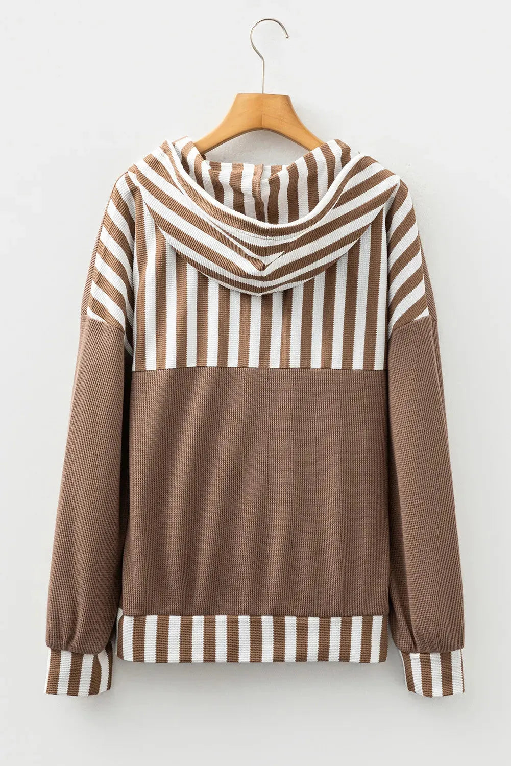 Straw yellow hoodie with waffle texture fabric, striped patchwork design, and button neck closure.