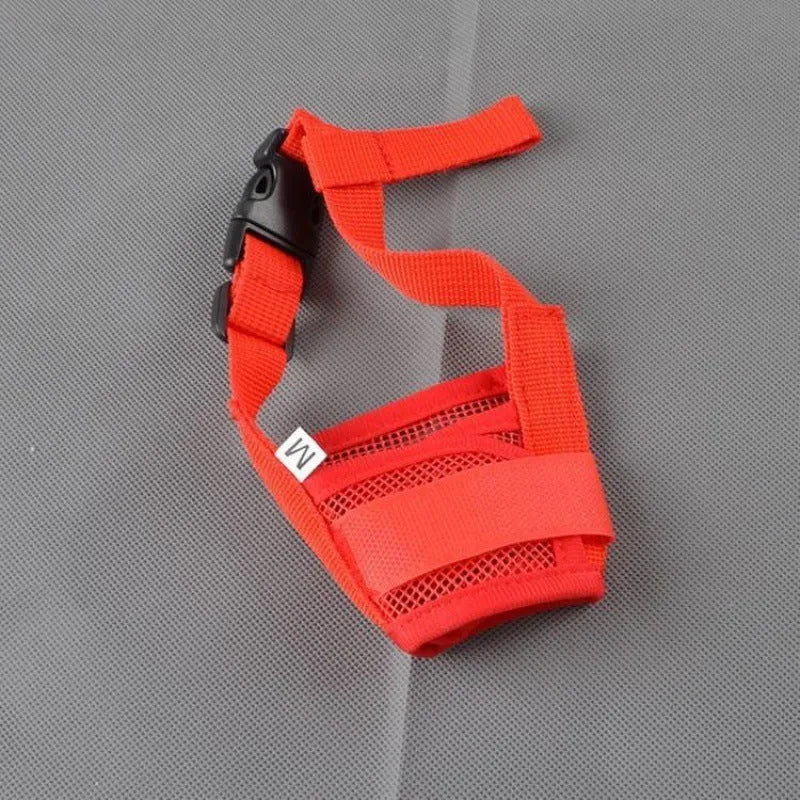 Adjustable plastic basket-style dog muzzle in red, shown on a dog's snout with quick-release buckle.
