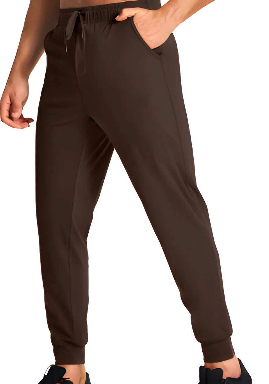 Men's loose-fitting casual polyester trousers in a solid colour on a hanger.