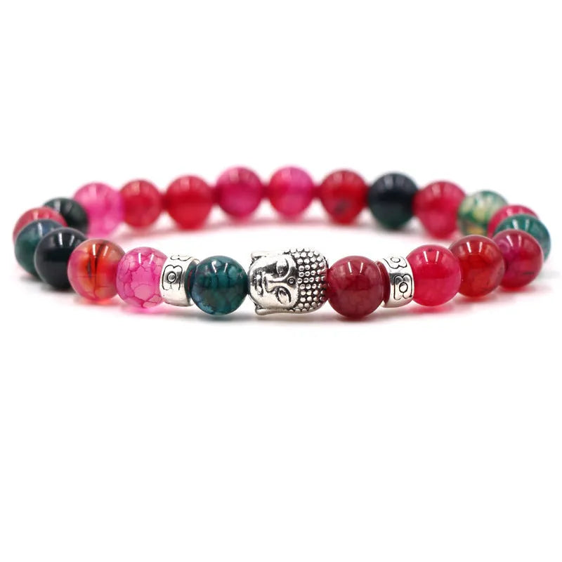 Tigereye stone Buddha head stretch bracelet with 8mm beads on a wrist.