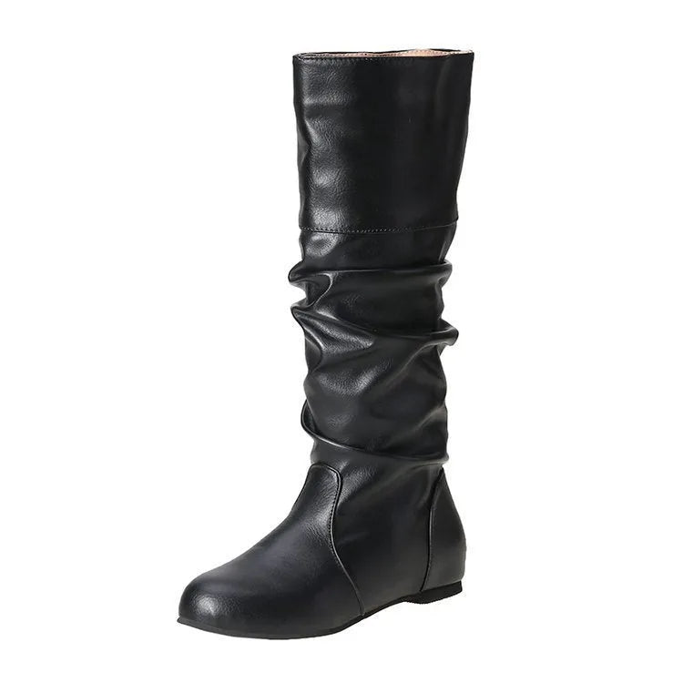 Women's black slip-on long boots with flat heel and round toe on a plain background.