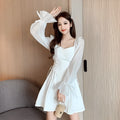 White chiffon patchwork dress with long sleeves, long skirt, and a waist-slimming design on a mannequin.