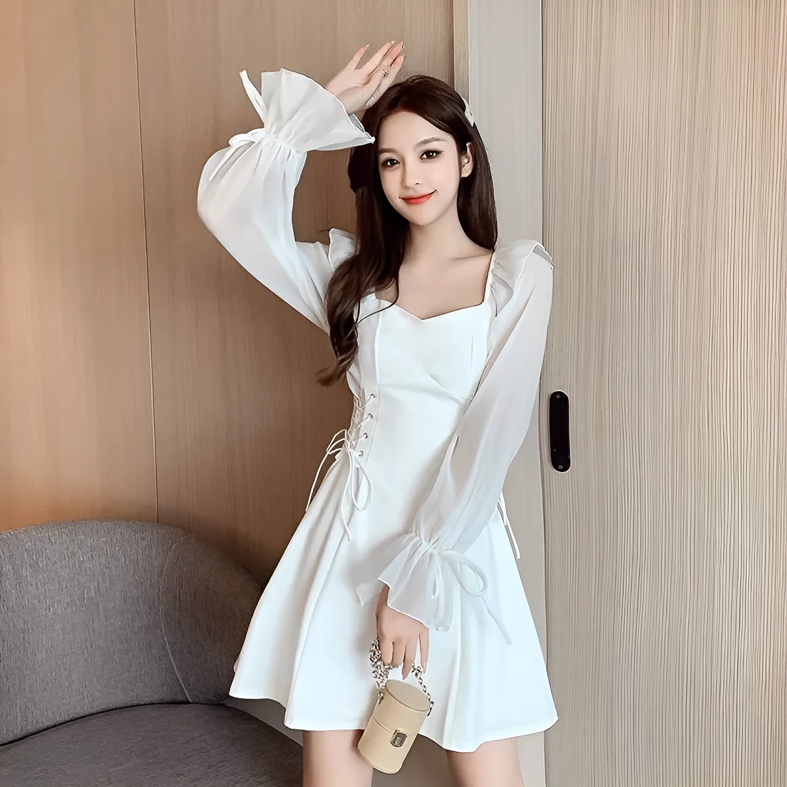 White chiffon patchwork dress with long sleeves, long skirt, and a waist-slimming design on a mannequin.