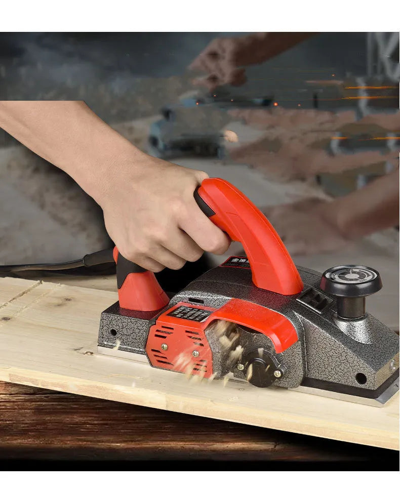 Red electric wood planer with aluminium body and 82mm planing width for household carpentry