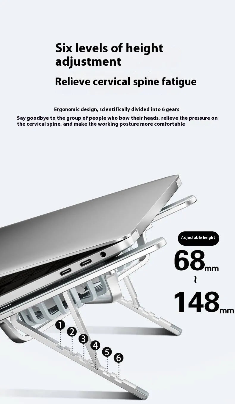 Silver aluminium laptop stand with twin fans raised at an angle on a wooden desk.
