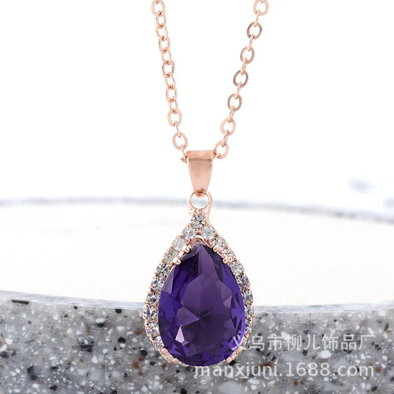 Rose gold water drop shape necklace with rhinestone geometric detailing in pink colour