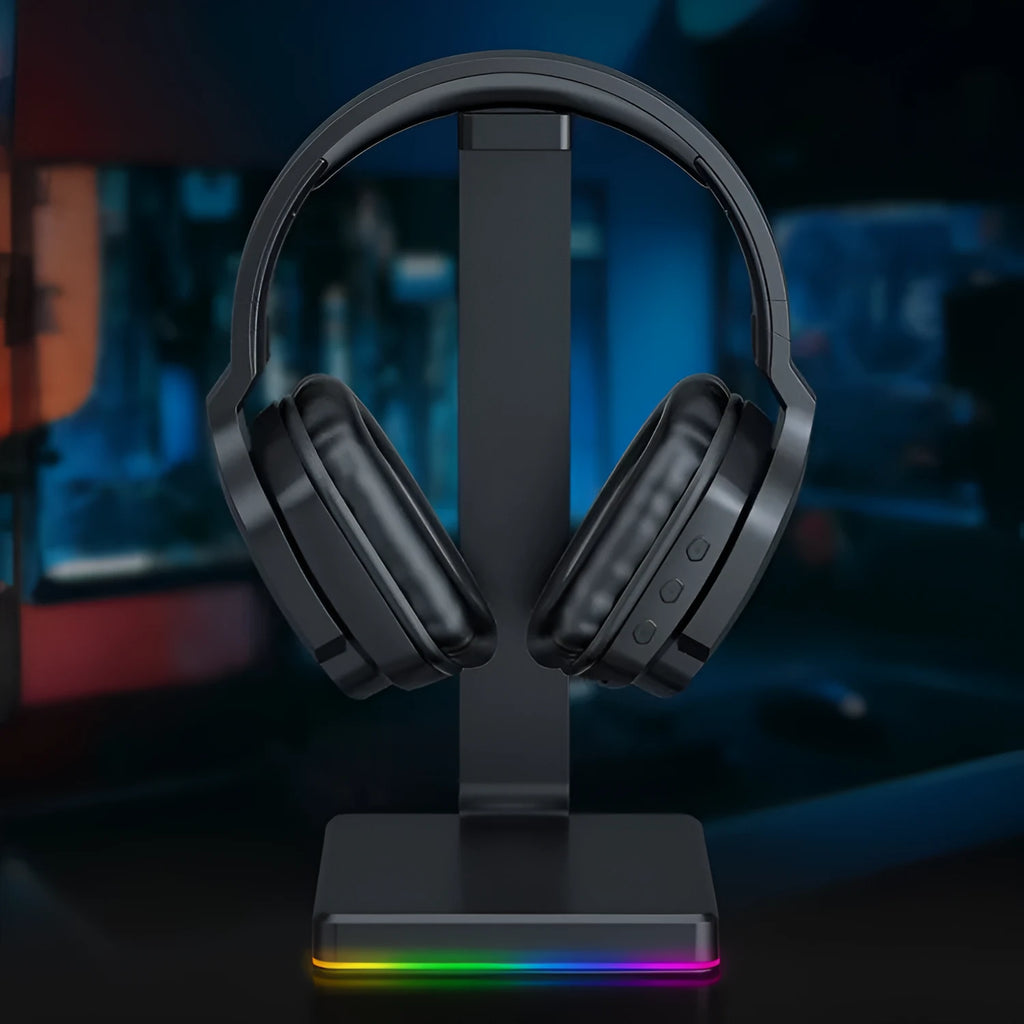 Luminous black wireless gaming headphones showing head-mounted design and included 3.5mm cable.