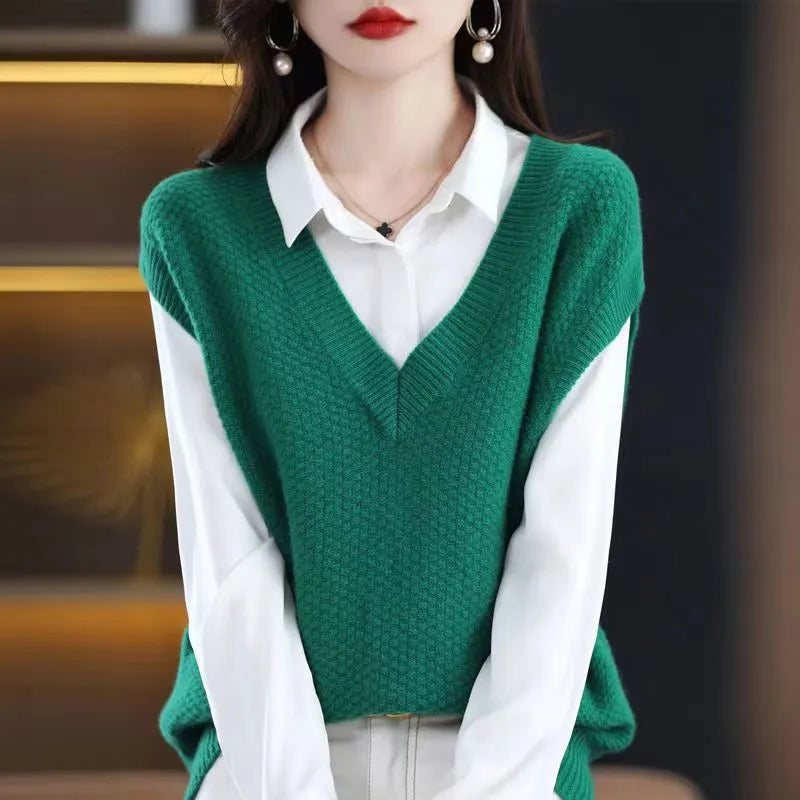 V-neck sleeveless knitted beige vest with a raised 3D pattern, laid flat.