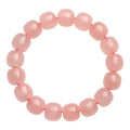 Pink crystal barrel bead stretch bracelet with 8-10mm polished beads on a wrist.