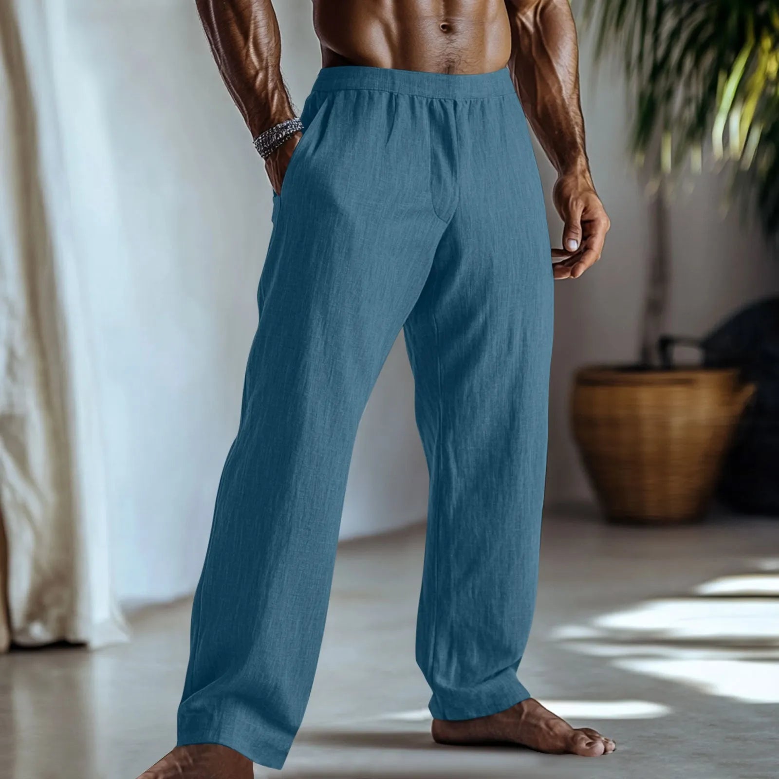 Straight leg cotton linen trousers in light green colour with visible front pockets on a plain background