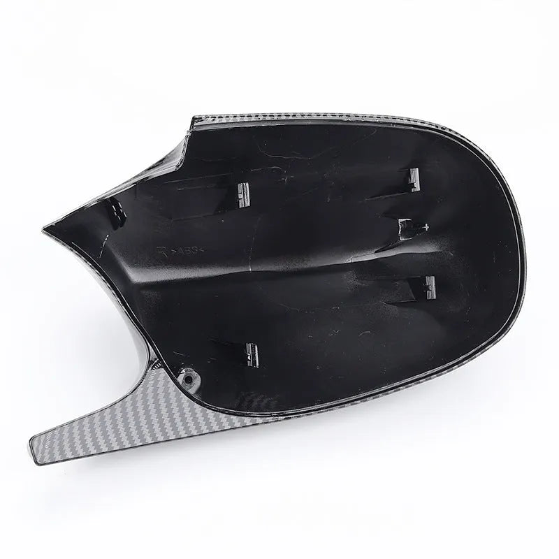 Pair of black ABS plastic rearview mirror shells for BMW 3 Series E90, shown alongside original equipment part numbers.