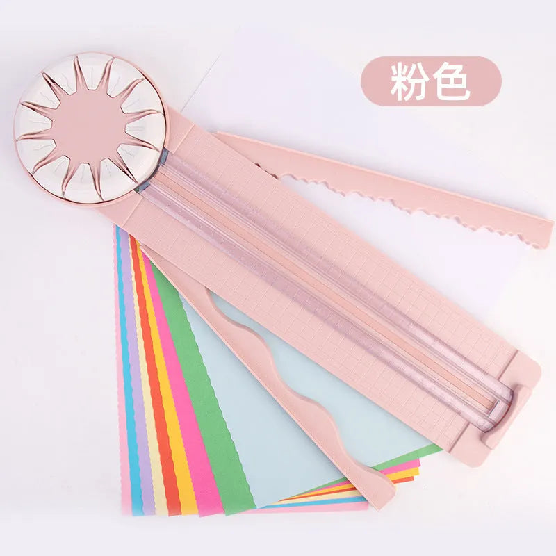 Pink plastic 12-in-1 multifunctional paper cutter with dotted guide lines on a white surface.