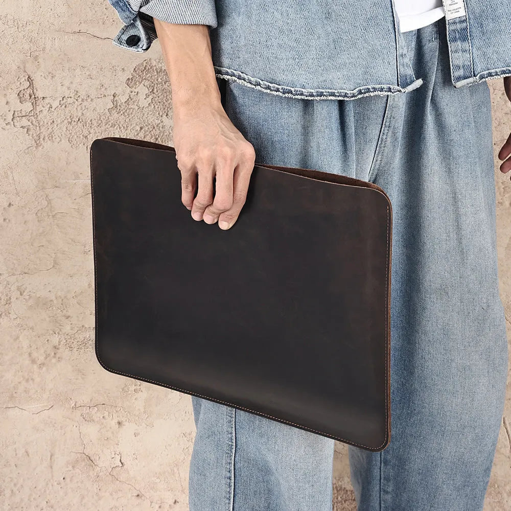 Brown Crazy Horse leather horizontal computer liner bag with a laptop inside