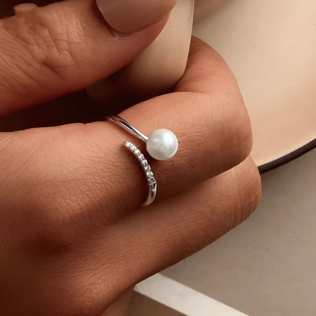 Adjustable sterling silver ring with natural shell pearls and open loop design