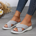 Women's black wedge slippers with peep-toe design and cross-strap PVC upper on thick rubber sole