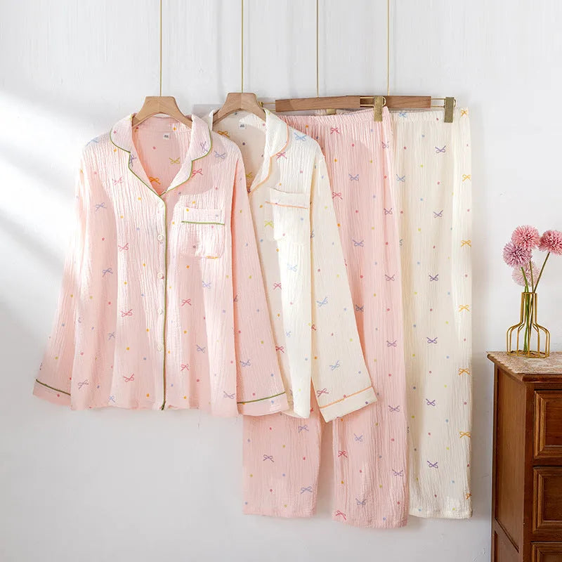 Beige and pink women's long-sleeved cotton pajama set with trousers on a hanger.